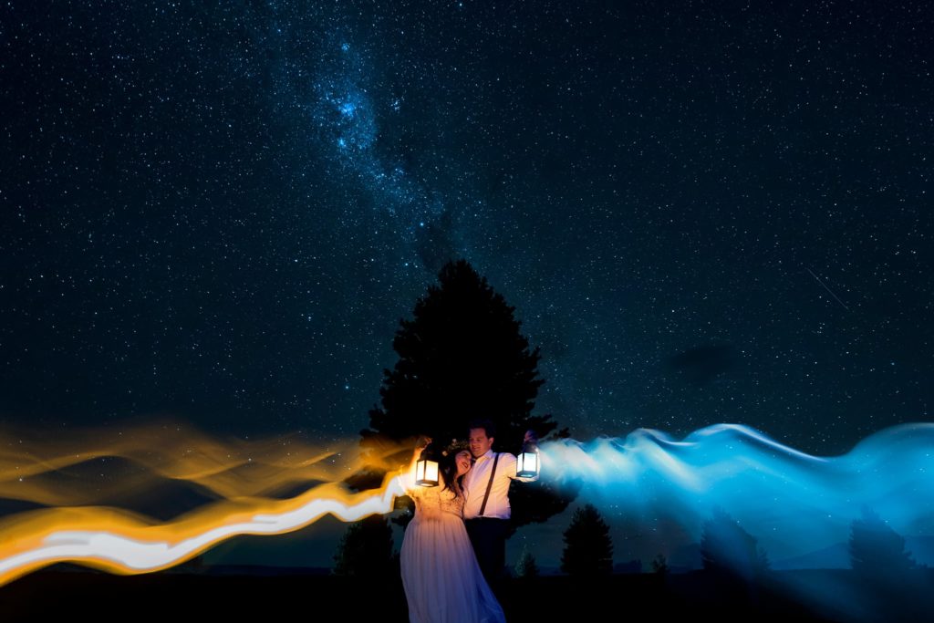 Bride and Groom in Wedding Attire Holding Lanterns at Their Gorgeous Mount Cook Elopement 