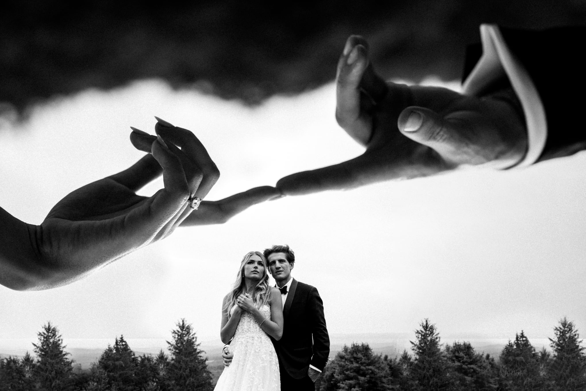 Double Exposure Image of Couple embracing in the background with their hands touching in the foreground