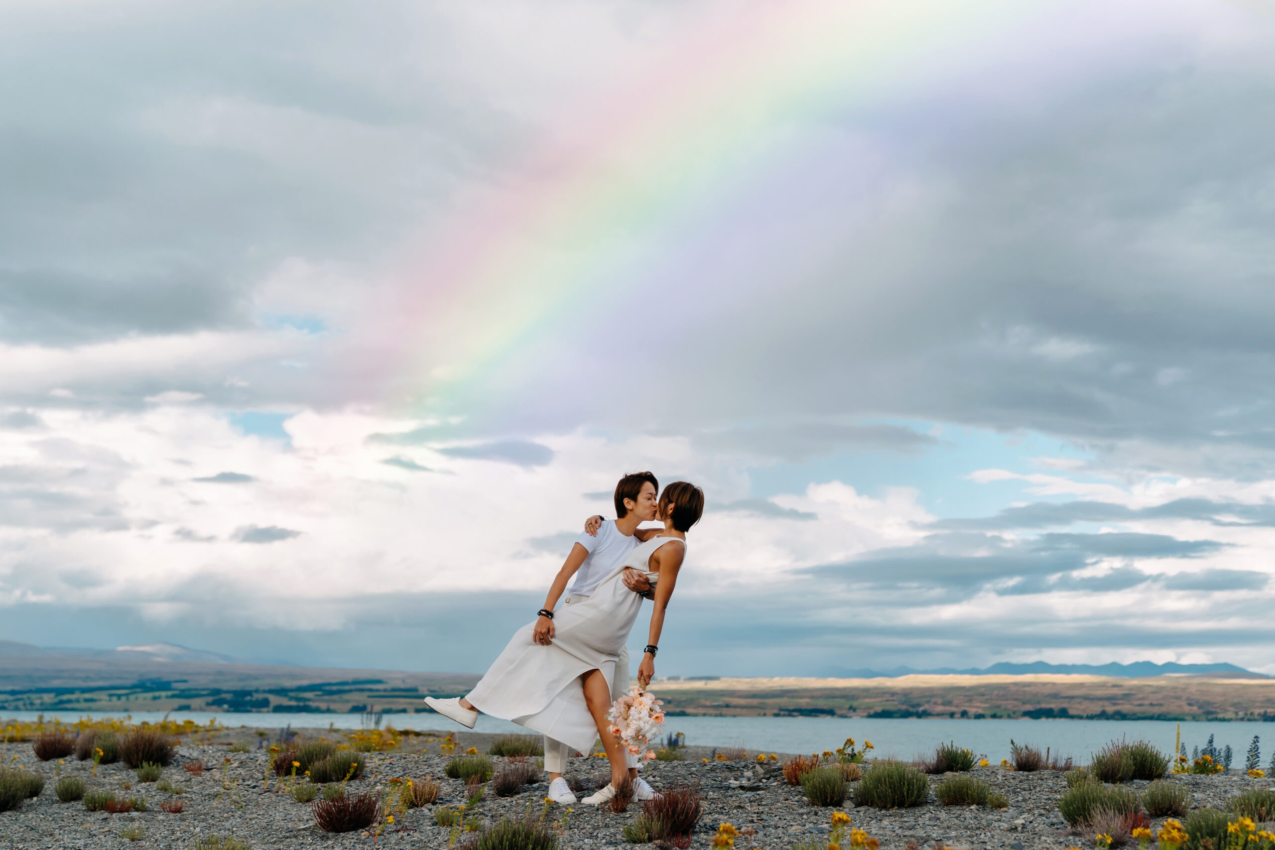 A Heartwarming Same-Sex Elopement in Mount Cook National Park with a rainbow in the background
