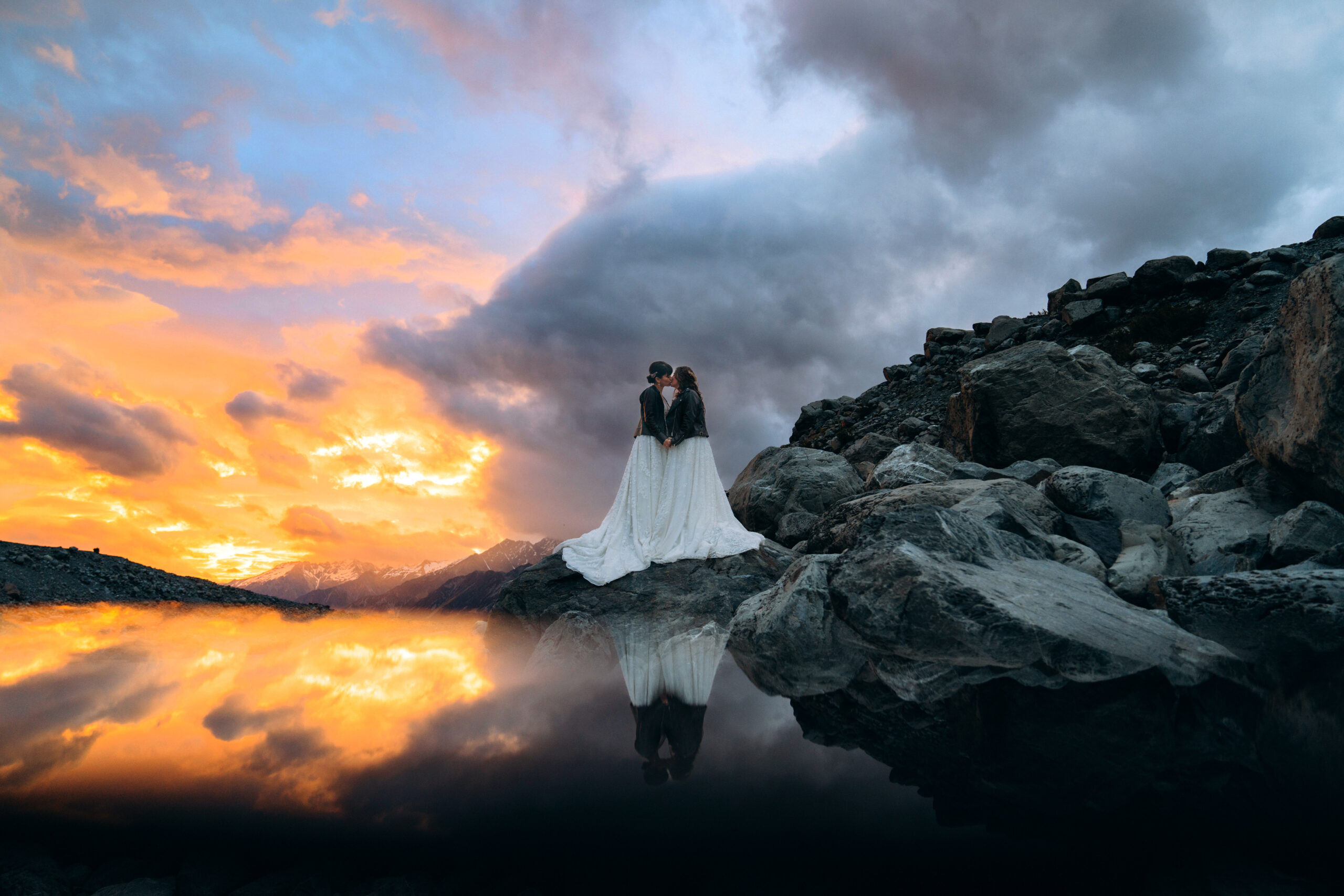 Sunset in Mount Cook National Park during a romantic same sex elopement, two brides kissing