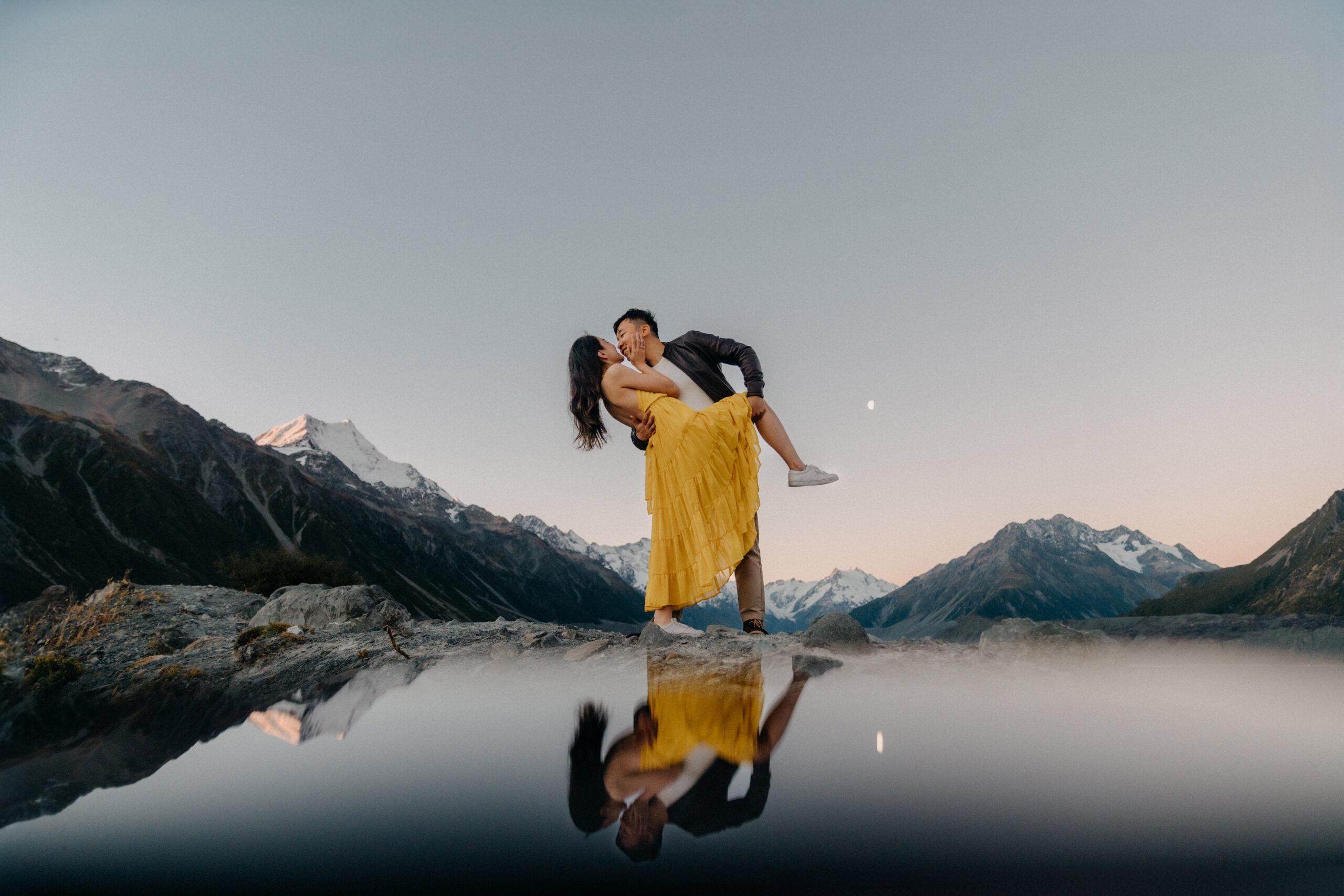 A romantic moment captured after a surprise proposal in Mount Cook National Park