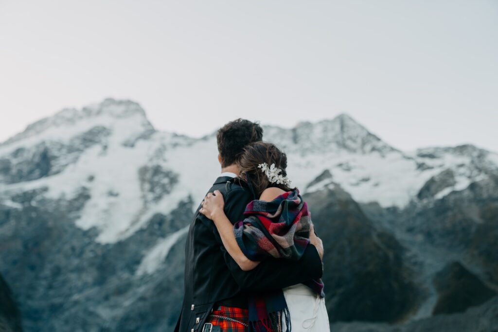 couple embracing in mount cook after eloping