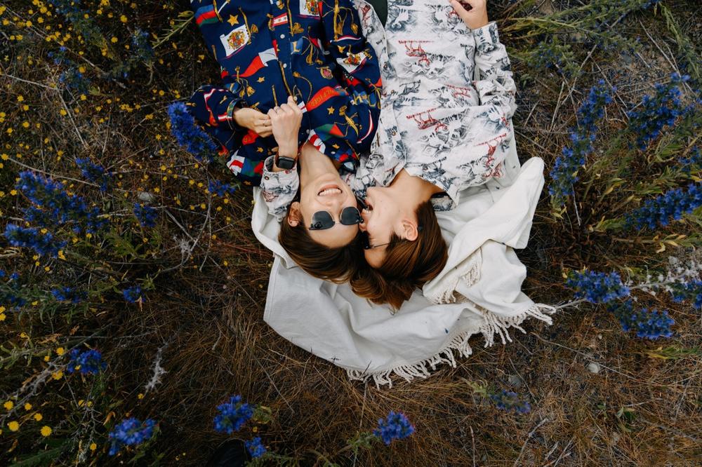 lesbian couple eloping in non-traditional wedding attire in new zealand