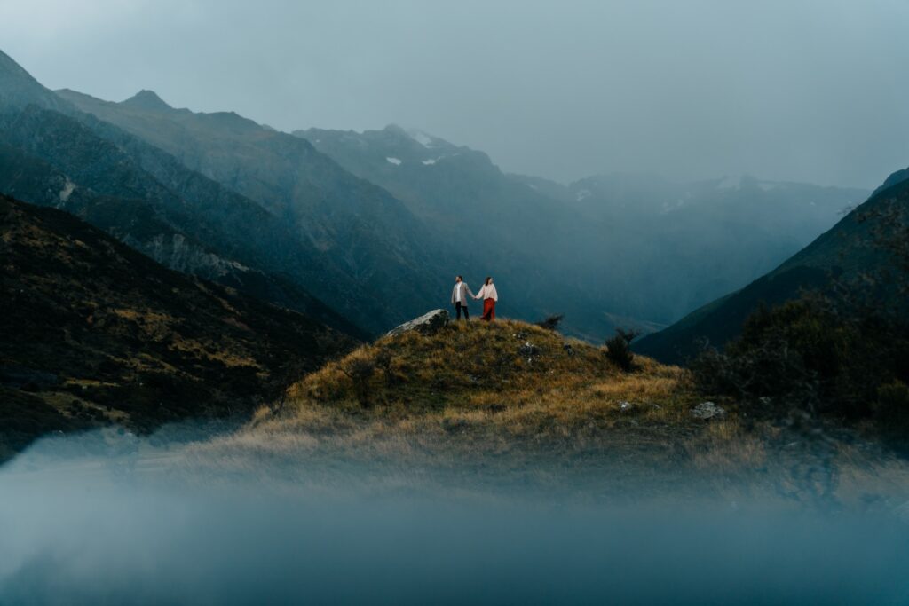 couple atop a mountain in adventurous elopement