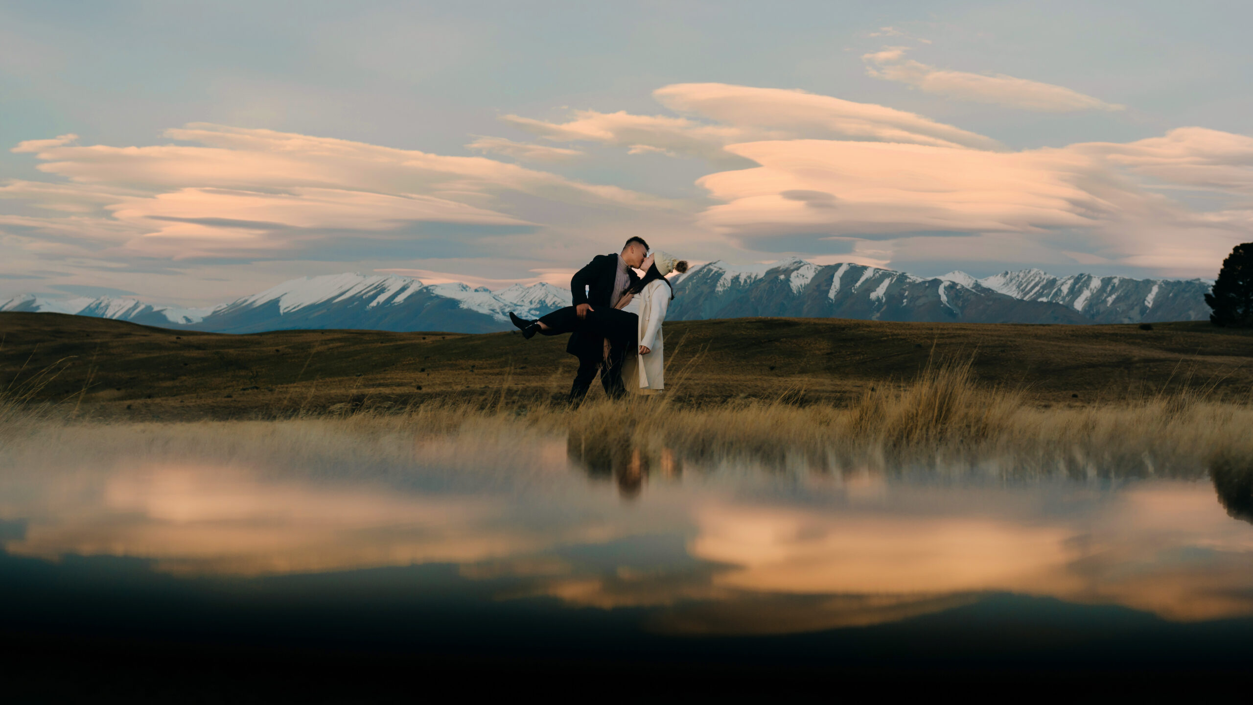 Couple kissing with Tekapo mountains in the backdrop