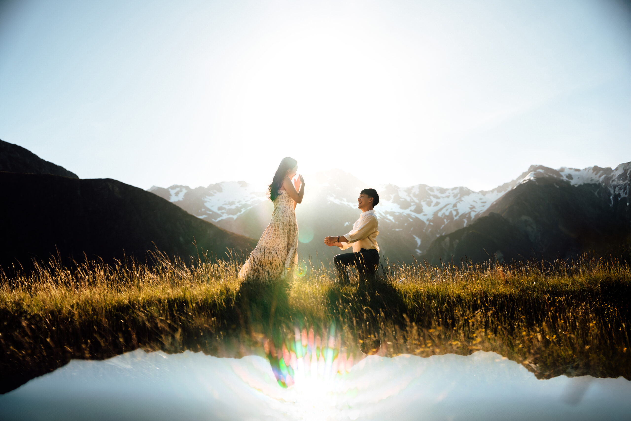 Surprise proposal in Mount Cook National Park with mountain reflection and golden sunset light